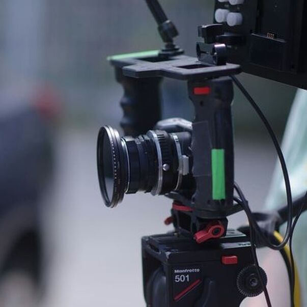 Blackmagic Pocket Cinema camera mounted on tripod in cage